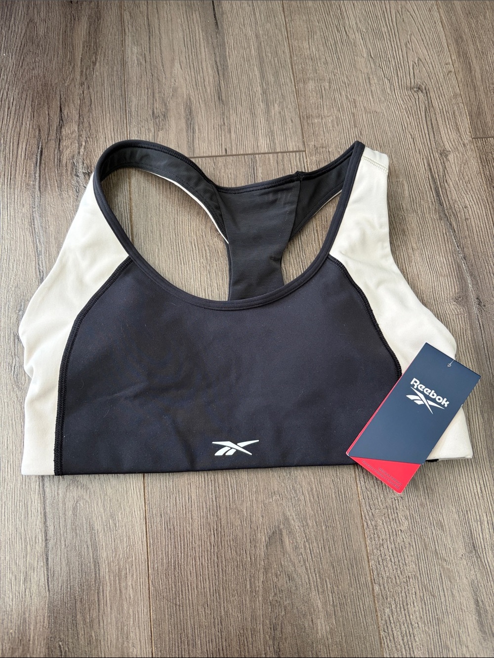 NWT Reebok Black and Cream Racerback Performance Sports Bra. Women’s size Small